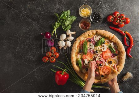 Cropped Shot Of Female Hands And Cooked Italian Pizza With Fresh Ingredients On Dark Tabletop