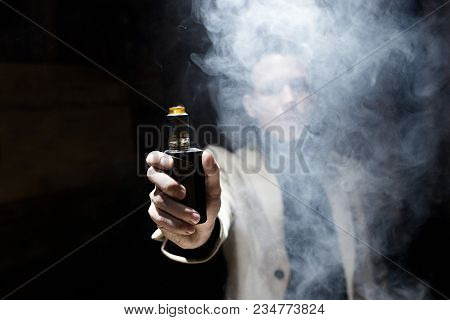 The Guy Smokes Vape. A Large Cloud Of Smoke