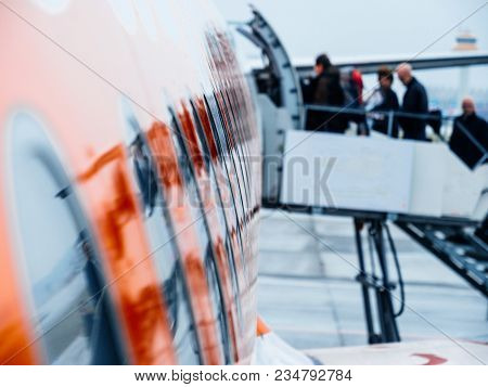 Defocused Unrecognizable Silhouette Of People Entering Airplane Early In The Morning In Flughafen Ha