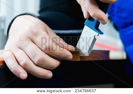 A Close-up Of The Real Male Carpenter's Not Well-groomed Hands Completes The Finish Of The Chipboard