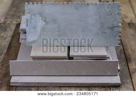 Laying And Cutting Tiles. Tools And Building Materials At A Working Position. Tiles For Industrial A