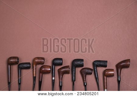Different Smoking Tobacco Pipes On Dark Background With Copy Space. Top View.