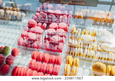 Assortment Of Colorful Macaroons On Cafe Showcase. Variety Of Macaron Flavours. Sweet Almond Cakes I