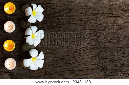 Spa Concept Background With Stone ,frangipani Or Plumeria  And Burning Candles On Wood With Copy Spa