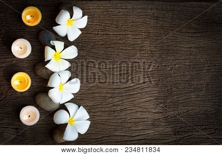 Spa Concept Background With Stone ,frangipani Or Plumeria  And Burning Candles On Wood With Copy Spa