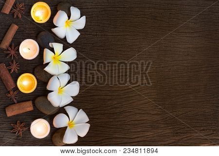 Spa Concept Background With Stone ,frangipani Or Plumeria  And Burning Candles On Wood With Copy Spa