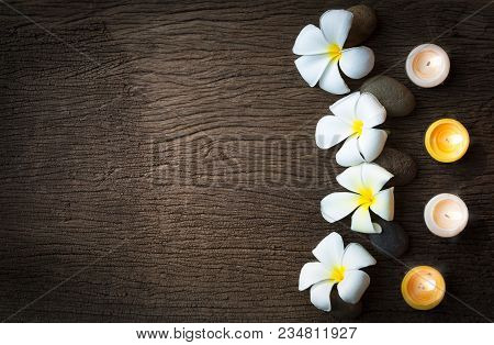 Spa Concept Background With Stone ,frangipani Or Plumeria  And Burning Candles On Wood With Copy Spa