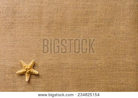 Starfish On Burlap Fabric Texture Background/summer Beach Vacation Concept