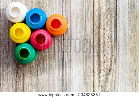 Colorful Paint Bottels On Rustic Wooden Background With Copy Space, Top View/arts And Crafts Backgro