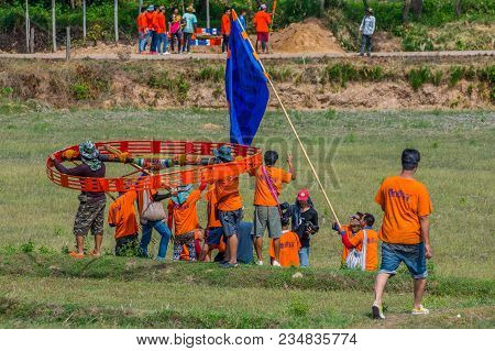 Kalasin, Thailand - May 22, 2016: People Carrying Ancient Style Rocket To Put In Place Prepare Launc