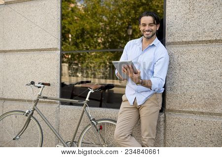 Young Happy Attractive Hispanic Man In Casual Trendy Clothes Smiling Cheerful Using Internet With Di