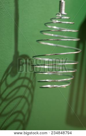 Different Kitchen Tools For Cooking Hanging On The Wall