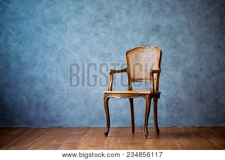 Old Chair On A Gray Wall Background
