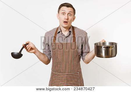 Man Chef In Striped Brown Apron Holding Silver Stainless Glossy Aluminium Empty Stewpan, Pan Or Pot,