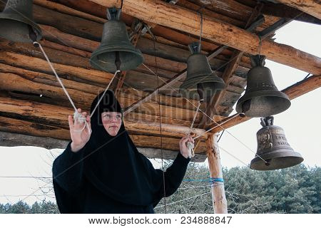 Starosillia, Volyn / Ukraine - February 04 2009: Woman Bell-ringer In Orthodox Church Bell Tower