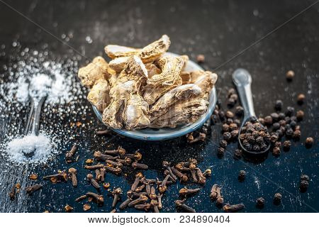 Close Up Of Ayurvedic Herb Or Folk Medicine Dried Ginger Or Zingiber Officinale With Black Pepper Co