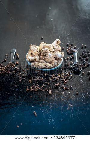 Close Up Of Ayurvedic Herb Or Folk Medicine Dried Ginger Or Zingiber Officinale With Black Pepper Co