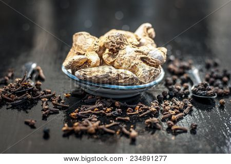 Close Up Of Ayurvedic Herb Or Folk Medicine Dried Ginger Or Zingiber Officinale With Black Pepper Co