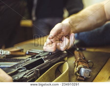 Man Disassemble Rifle Close Up On The Table