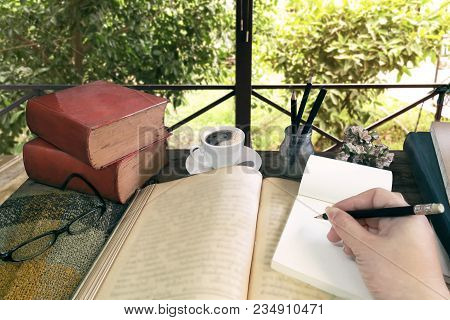Old Books With Treatise, Glasses And Pencil On A Wooden Table In The Garden. Concept Education.