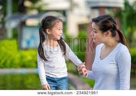 Little Girl Is Playng With Mother In The Park.