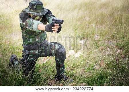 Special Forces Soldier Or Private Millitary Sit Holding Gun Aiming.