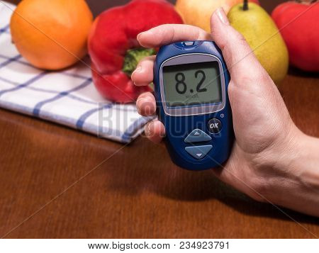 Diabetes Checking Blood Sugar Level. Woman Using Lancelet And Glucometer At Home.
