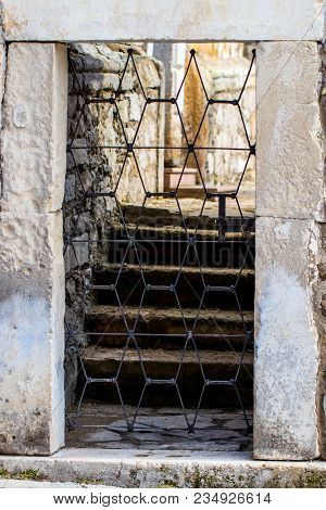Stone Wall Entrance To A Garden, Security Closed Entrance Door.