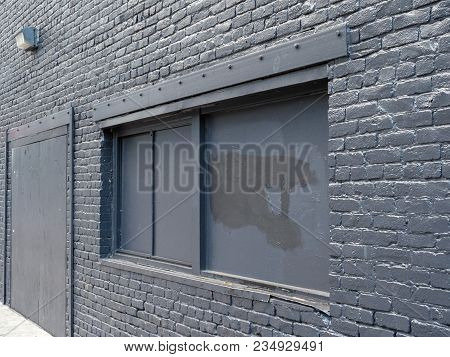 Abandoned Building, Boarded Up And Painted Black. Outdoors Shot