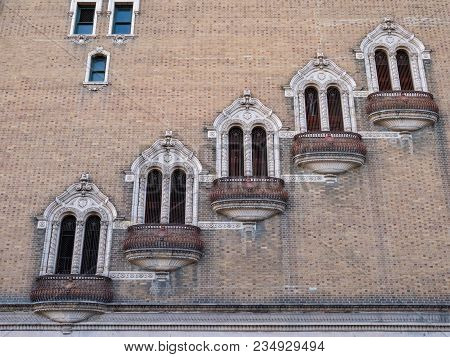 Row Of Staggered, Rusty, Outdoor Balconies On The Side Of A Building
