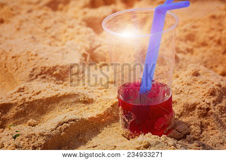 Red Cocktail On The Beach At Sunset With Blurred Background. Vertical