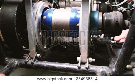 A Team Of Engineers Turns The Nuts With Horn Keys On The Car, Remove The Internal Combustion Engine