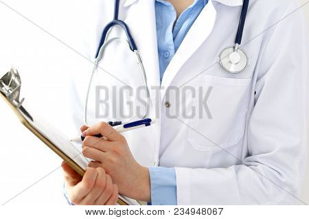 Female Doctor Filling Up Medical Form On Clipboard Closeup.  Physician Finishing Up Examining His Pa