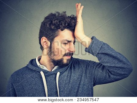 Regrets Wrong Doing. Portrait Silly Young Man, Slapping Hand On Head Having A Duh Moment Isolated On