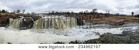 The Big Sioux River Flows Over Rocks In Sioux Falls South Dakota With Views Of Wildlife, Ruins, Park