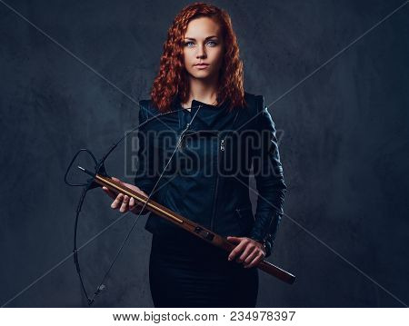 Redhead Female Dressed In An Elegant Suit Holds Crossbow.
