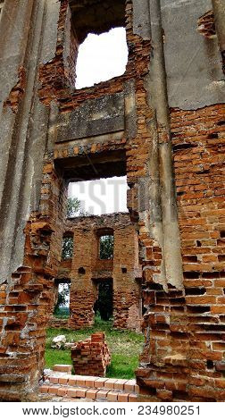 An Old Broken Brick Wall With Cracks. Ruined Wall Of The Old Cathedral.