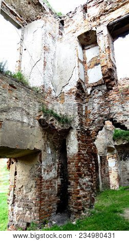 An Old Broken Brick Wall With Cracks. Ruined Wall Of The Old Cathedral.