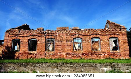 An Old Broken Brick Wall With Cracks. Ruined Wall Of The Old Cathedral.