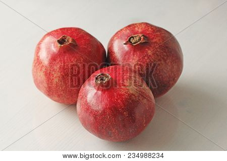 Big Ripe Red Granets Or Garnets. Fruits Of Red Ripe Pomegranate On The White Background. Vegetarian 