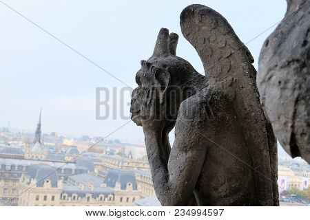 Chimeras (gargoyles) Of The Cathedral Of Notre Dame De Paris Overlooking Paris, France