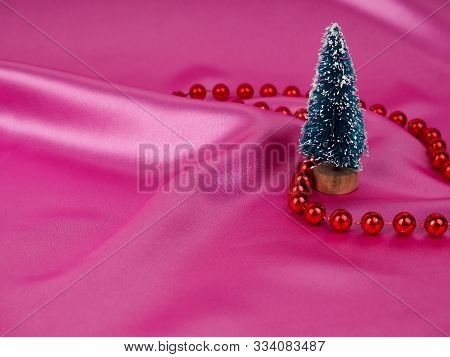Christmas Tree On A Background Of Shiny Pink Satin As Background, Silk Background, Christmas Card. H