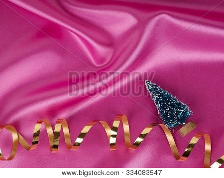 Christmas Tree On A Background Of Shiny Pink Satin As Background, Silk Background, Christmas Card. H