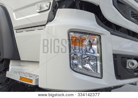 White Truck Cab. Fragment. Headlight And Bumper, Footrest And Door. Front Side View.