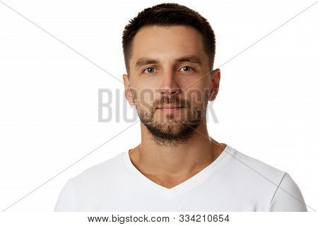 Young Handsome Bearded Man In Casual White Sweater Poses In Studio On White Background