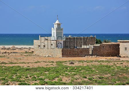 Mosque on Socotra island (Yemen) with turquoise sea background
