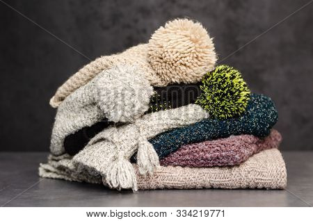 A Stack Of Folded Knitted Winter Scarves And Hats. Season Of Warm Clothes. Time To Keep Warm. Closeu