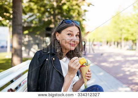 Cheerful Beautiful Mature European Female In Her Fifty Enjoying The Nice Summer Weather Outdoors, Si