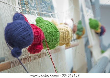 Various Yarn On Weaving Handmade Carpet . Manual Production Of Carpets .round Wooll Yarn . Ball Wool