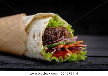 Tasty Doner Kebabs With Fresh Salad Trimmings And Shaved Roasted Meat Served In Tortilla Wraps On Br
